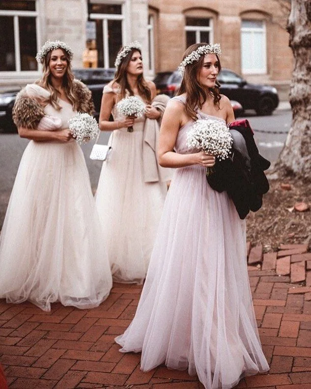 Bridesmaids wearing pale Luna tulle gowns at a city wedding